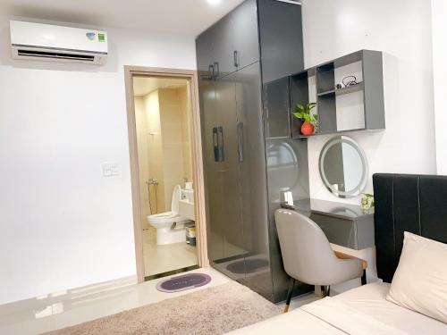 a bathroom with a shower and a sink and a toilet at Hue Charm Apartment with Pool and Gym in Thôn Văn Dương