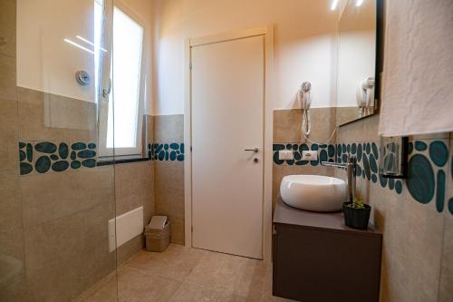 a bathroom with a sink and a shower at CALLIA ROOMS PROCIDA in Procida