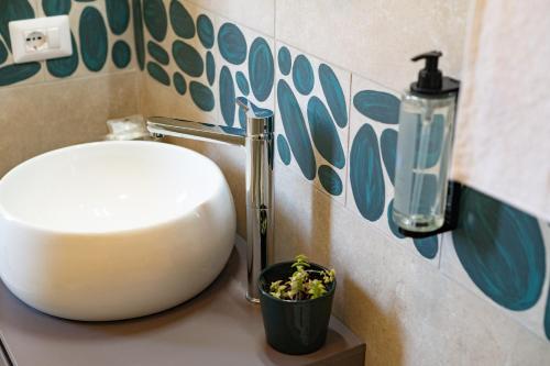 プローチダにあるCALLIA ROOMS PROCIDAの洗面台(鉢植えの植物付)