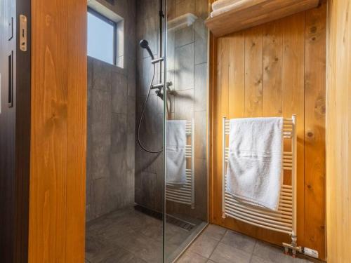 uma casa de banho com um chuveiro e uma porta de vidro em Oguma House em Nozawa Onsen