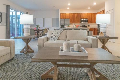 a living room with a couch and a table at Summer Fun - Waterfront 8BR Home with Private Pool! in Kissimmee