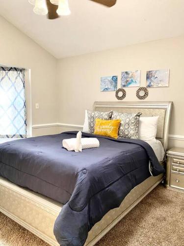 a bedroom with a large blue bed with pillows at Relaxing Oasis with Pool Gazebo in Family-Friendly Neighborhood in Montgomery