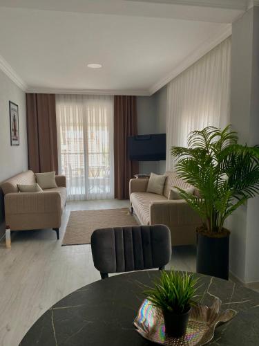 a living room with a couch and a table at Turgutsluxury 4 in Fethiye