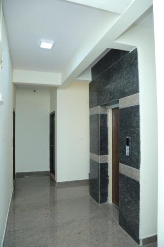 an empty hallway with a door in a building at Hotel Bangalore Airport inn, Airport Pickup & Drop Available 24X7 in Yelahanka