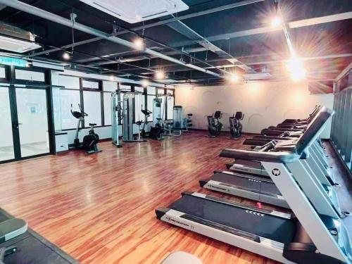 a gym with treadmills and elliptical machines at Selesa Homestay Canopy Hills Kajang in Hulu Langat