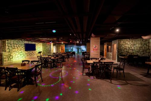 a dining room with tables and chairs and lights on the floor at Fantasy Palace in Yuchi