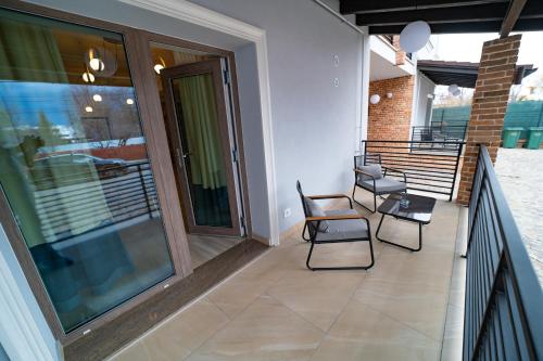 a balcony with two chairs and a table at First Apartments in Focşani