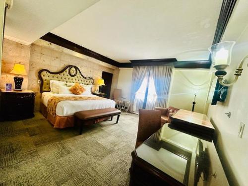 Hotel Real de Don Juan في تيبيك: غرفه فندقيه بسرير ونافذه