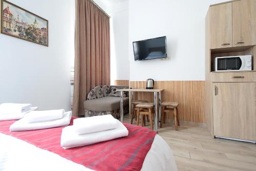 a hotel room with a bed with two white towels at Deluxe Apartments on Doroshenka 29 in Lviv