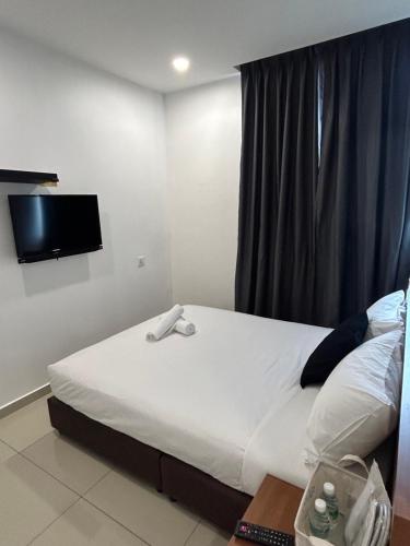 Кровать или кровати в номере Tt Pets and Family Guesthouse Kota Laksamana, Melaka