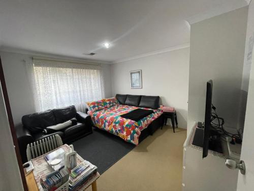 a living room with a couch and a bed at Telperio - Guest suite max 4 Guests in Bunbury