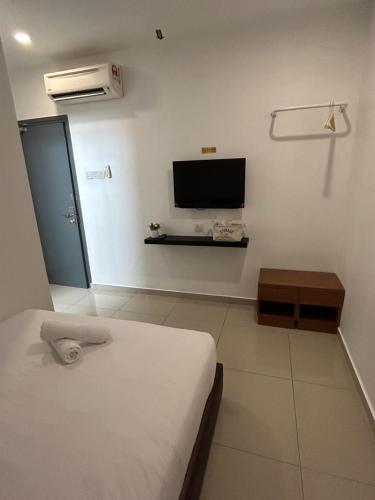Телевизор и/или развлекательный центр в Tt Pets and Family Guesthouse Kota Laksamana, Melaka
