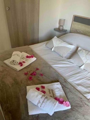 - un lit avec 2 serviettes et des fleurs dans l'établissement T2 - Résidence Plein Sud, à Cabourg