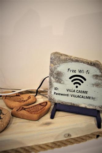 a sign sitting on top of a table with bread at Symi . VILLA CALME (Sur la Mer). in Symi