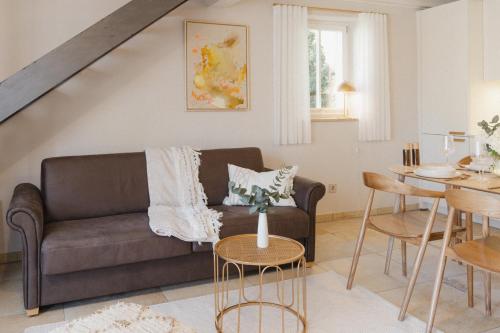 a living room with a couch and a table at Ferienwohnung Weidenbach in Weidenbach