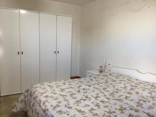 a bedroom with a bed and white cabinets at Mansarda arredata in Floridia