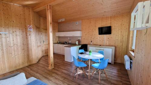 a kitchen with a table and chairs in a room at Marina Złotowo in Złotowo