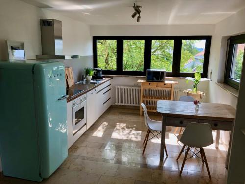 cocina con nevera verde y mesa en ☆ Zentrales Appartement mit traumhaftem Panorama ☆, en Winnenden