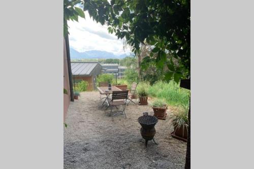 eine Terrasse mit einem Tisch, Stühlen und Topfpflanzen in der Unterkunft Gartenwohnung 5 min. zur Stadt in Hagenau