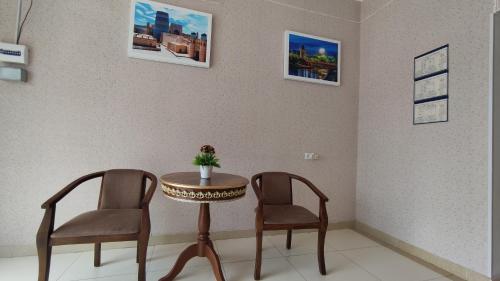 a table and two chairs in a waiting room at Safiya hostel in Urganch