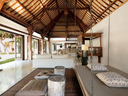 a living room with a bed and a couch at Casa Evaliza in Seminyak