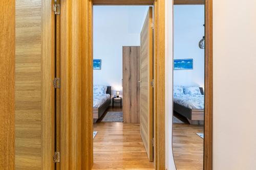 a hallway with two beds in a room at FOREST GREEN in Kolašin
