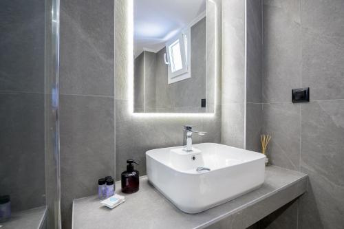 a bathroom with a white sink and a mirror at Gianni's comfort by homebrain in Alexandroupoli