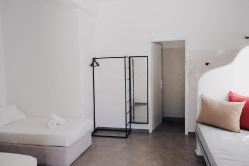 a living room with a bed and a couch at Paradise Apartments Studios in Mylopotas