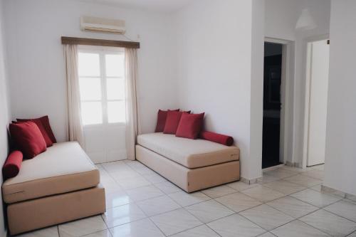 a living room with two chairs and a couch at Paradise Apartments Studios in Mylopotas