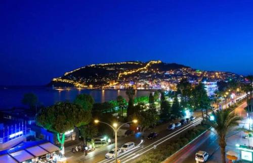 a view of a city at night with a mountain at Alanya My Boutique Hotel in Alanya