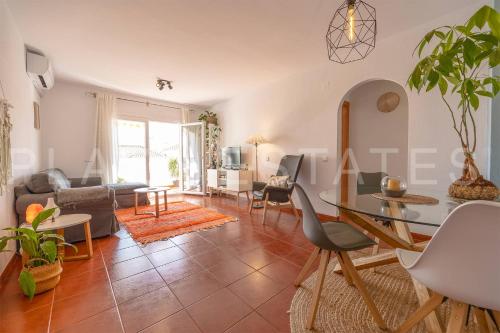 a living room with a table and a couch at Bonito piso a 300m de la playa Nerja in Nerja