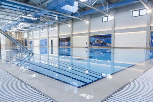 a swimming pool in a building with an empty floor at Harmony Studio Apartment in Jagodina