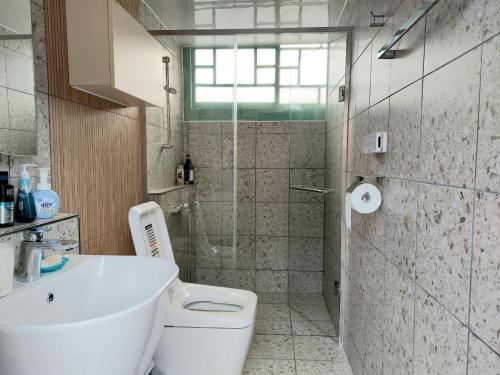 a bathroom with a toilet and a sink and a shower at Leedo Hanok in Seoul