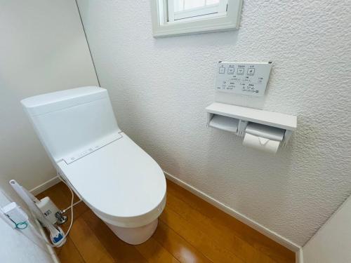a bathroom with a white toilet in a room at Prime 糸島 in Itoshima