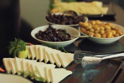 a table topped with cheese and other dishes of food at Air Barbaros Hotel Trabzon in Trabzon