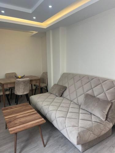 a living room with a couch and a table at Square Vanilla Boutique Apart-Hotel in Skopje