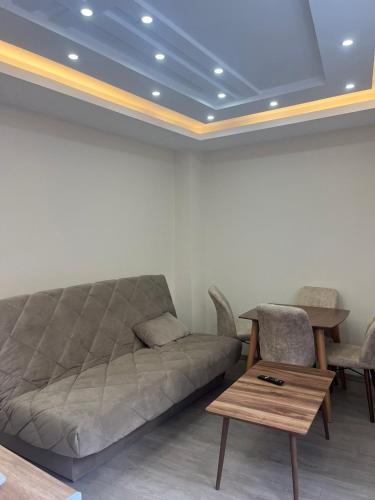 a living room with a couch and a table at Square Vanilla Boutique Apart-Hotel in Skopje
