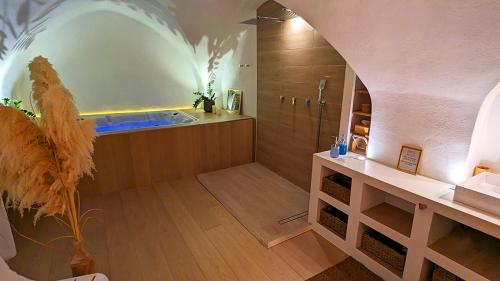 a large bathroom with a tub and a shower at Suite 6 in Nîmes