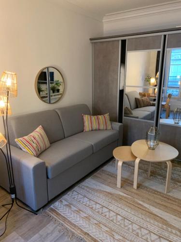 a living room with a couch and a table at Studio moderne au cœur de Paris Batignolles in Paris