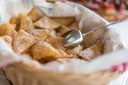 a basket of food with a spoon in it at Hotel Anewandter in Brunico