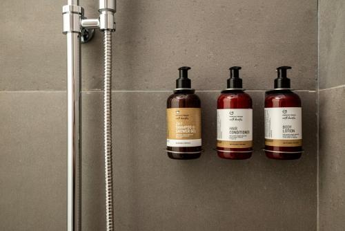 four bottles of wine on a wall in a bathroom at RASTONI VILLAS BY AEGEAN HOUSES in Psalidi