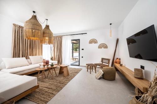 a living room with a couch and a table at RASTONI VILLAS BY AEGEAN HOUSES in Psalidi