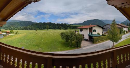 a view from the balcony of a house with a green field at Schroider in Kössen