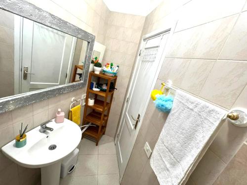 a bathroom with a sink and a shower with a mirror at Rustic apartment close to the beach of Alcalá! in Alcalá