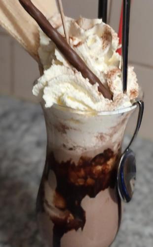 a glass cup filled with ice cream and whipped cream at Zimmer und Appartement Marktcafe Sankt Peter am Kammersberg 87 in Sankt Peter am Kammersberg