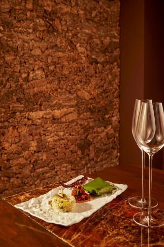 a table with a plate of food and a wine glass at Taj Exotica Resort & Spa, Andamans in Havelock Island