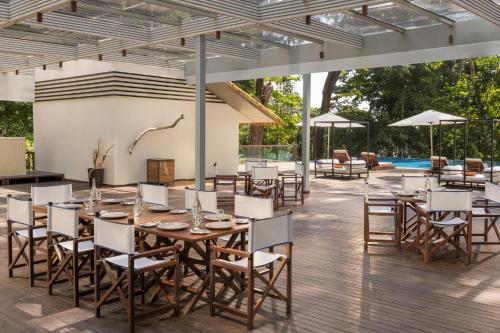 a patio with a table and chairs and a pool at Taj Exotica Resort & Spa, Andamans in Havelock Island