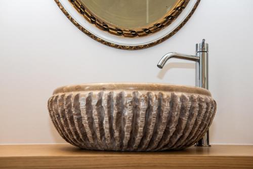 a bathroom sink in front of a mirror at Cosy Moods in Trieste