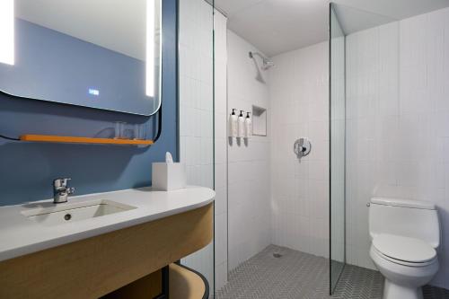 a bathroom with a toilet and a sink and a shower at Delta Hotels by Marriott New York Times Square in New York