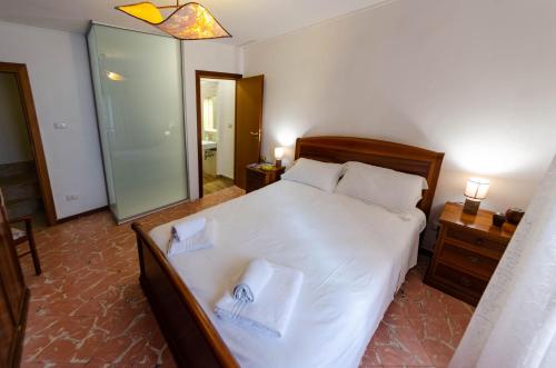 a bedroom with a bed with two towels on it at A due passi dal Duomo in Cefalù